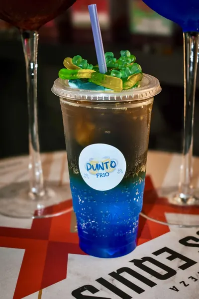 Bebida azul con gomitas y el logo de Punto Frío